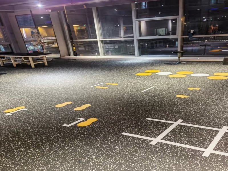 A close-up technical shot of rubber gym flooring showing its dense granule structure